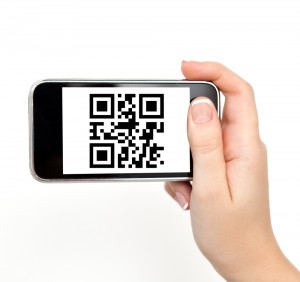 hand holding the phone tablet touch computer gadget with qr code 