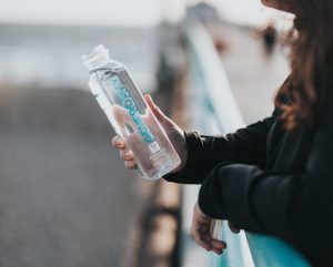 A person holding a custom bottled water